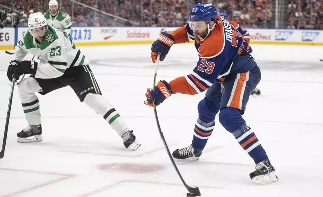 Dallas Stars' Esa Lindell (23) chases down Edmonton Oilers' Leon Draisaitl (29) as he gets a shot away during second period NHL Western Conference final playoff action, in Edmonton on Tuesday, May 27, 2025. (Jason Franson/The Canadian Press via AP)