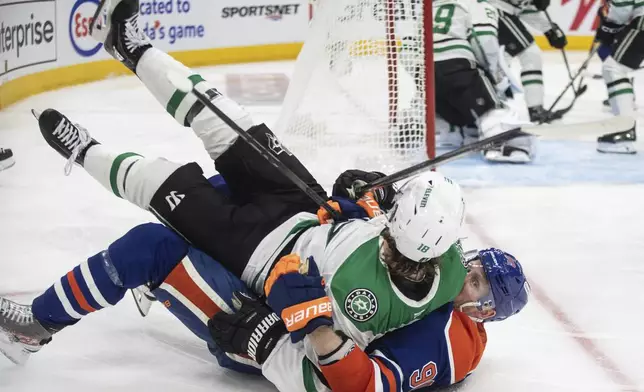 Dallas Stars' Sam Steel (18) and Edmonton Oilers' Corey Perry (90) get tangled up during second period NHL Western Conference final playoff action, in Edmonton on Tuesday, May 27, 2025. (Jason Franson/The Canadian Press via AP)