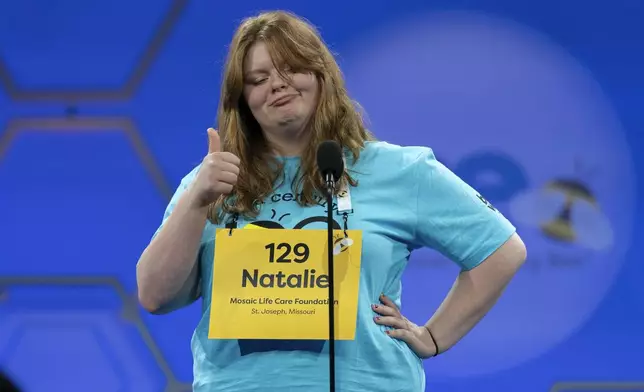 Natalie Mae Linthicum, 13, of St. Joseph, Mo., gestures as she spells her word during the first preliminary round of the Scripps National Spelling Bee at the Gaylord National Resort &amp; Convention Center, Tuesday, May 27, 2025, in Oxon Hill, Md. (AP Photo/Jose Luis Magana)