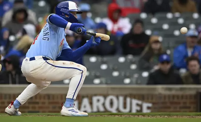 Chicago Cubs' Pete Crow-Armstrong watches his sacrifice bunt that scored Darby Swanson during the seventh inning of a baseball game against the Philadelphia Phillies, Friday, April 25, 2025, in Chicago. (AP Photo/Paul Beaty)