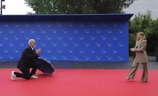 Albanian Prime Minister Edi Rama, left, welcomes Italy's Prime Minister Giorgia Meloni, ahead of a summit where the leaders of 47 European countries and organizations will discuss security, defense and democratic standards against the backdrop of Russia's war on Ukraine, in Tirana, Albania, Friday, May 16, 2025. (AP Photo/Vlasov Sulaj)