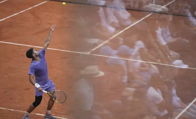 Spain's Carlos Alcaraz serves during a round of sixteen match against Russia's Karen Khachanov at the Italian Open tennis tournament in Rome, Tuesday, May 13, 2025. (AP Photo/Andrew Medichini)