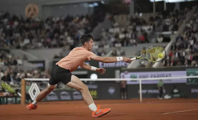 Hungary's Fabian Maroszan returns the ball to Spain's Carlos Alcaraz during their second round match of the French Tennis Open, at the Roland-Garros stadium, in Paris, Wednesday, May 28, 2025. (AP Photo/Christophe Ena)