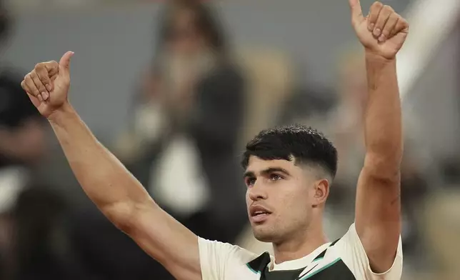 Spain's Carlos Alcaraz celebrates beating Hungary's Fabian Maroszan after their second round match of the French Tennis Open, at the Roland-Garros stadium, in Paris, Wednesday, May 28, 2025. (AP Photo/Christophe Ena)