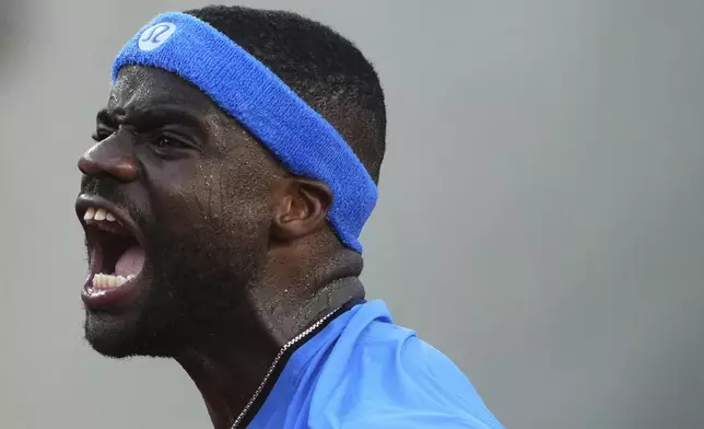 Frances Tiafoe of the U.S. reacts to winning a point against United States' Sebastian Korda during their third-round match of the French Tennis Open at the Roland-Garros stadium in Paris, Friday, May 30, 2025. (AP Photo/Lindsey Wasson)