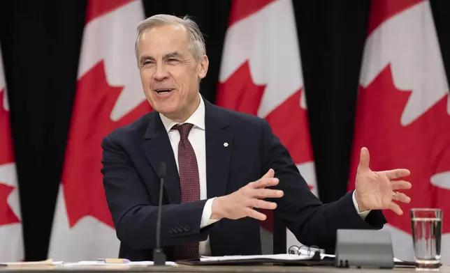 Prime Minister Mark Carney laughs as he responds to a question during a news conference, in Ottawa, Friday, May 2, 2025. (Adrian Wyld /The Canadian Press via AP)