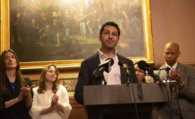 Mohsen Mahdawi, center, speaks during a press conference announcing the launch of the Vermont Immigration Legal Defense Fund in the Cedar Creek Reception Room at the Vermont State House on Thursday, May 8, 2025, in Montpelier, Vt. (AP Photo/Alex Driehaus)