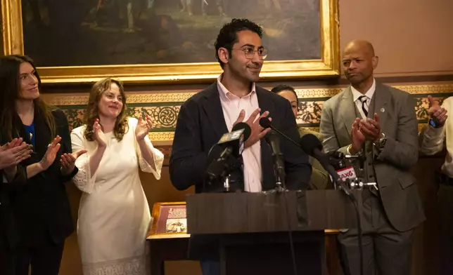 Mohsen Mahdawi, center, speaks during a press conference announcing the launch of the Vermont Immigration Legal Defense Fund in the Cedar Creek Reception Room at the Vermont State House on Thursday, May 8, 2025, in Montpelier, Vt. (AP Photo/Alex Driehaus)