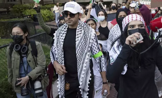 FILE - Mohsen Mahdawi, center, looks on during a pro-Palestinian protest at Columbia University, Thursday, Oct. 12, 2023, in New York. (AP Photo/Yuki Iwamura, File)