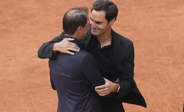 Rafa Nadal, left, hugs Roger Federer, during a farewell ceremony at center court Philippe-Chatrier, at the Roland-Garros stadium, in Paris, Sunday May 25, 2025. (AP Photo/Christophe Ena)