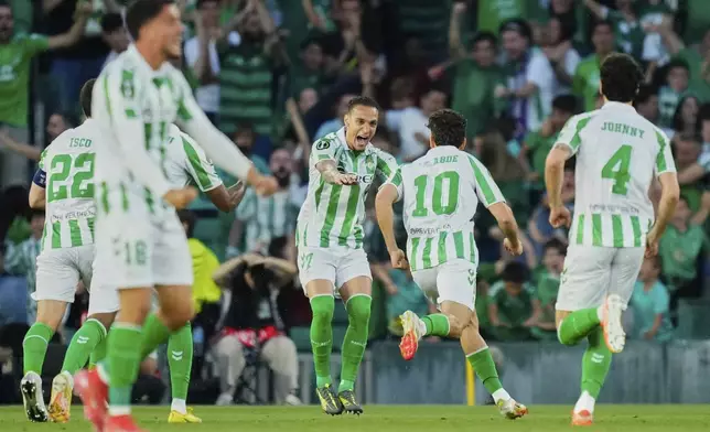 Betis players celebrate after a goal during the Conference League semifinal first leg soccer match between Betis and Fiorentina at the Benito Villamarin stadium in Seville, Spain, Thursday, May 1, 2025. (AP Photo/Jose Breton)