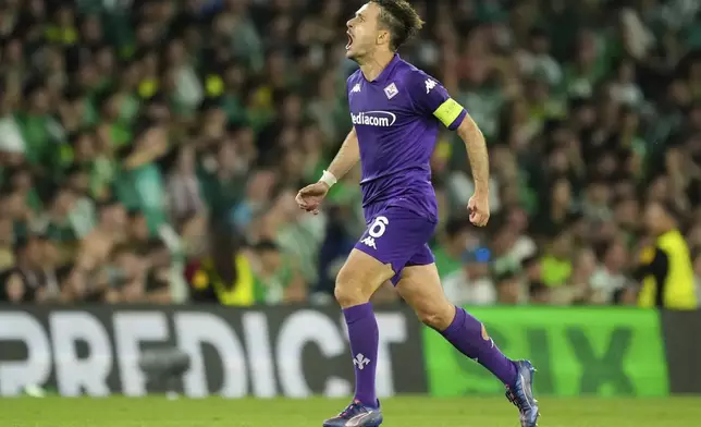 Fiorentina's Luca Ranieri celebrates after scoring during the Conference League semifinal first leg soccer match between Betis and Fiorentina at the Benito Villamarin stadium in Seville, Spain, Thursday, May 1, 2025. (AP Photo/Jose Breton)