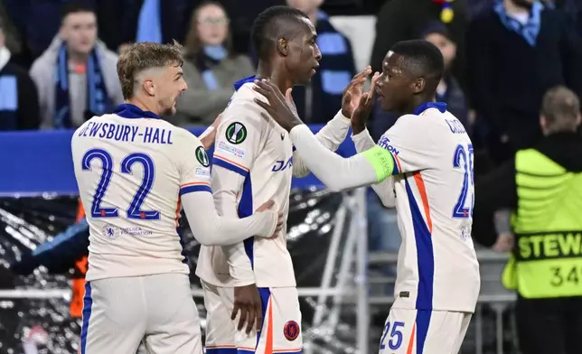 Chelsea's Nicolas Jackson, center, is congratulated by Kiernan Dewsbury-Hall, left, and Moises Caicedo, right, after scoring his side's third goal during the Conference League semi-final first leg soccer match between Djurgardens IF and Chelsea FC in Stockholm, Sweden, Thursday, May 1, 2025. (Jonas Ekstroemer/TT News Agency via AP)