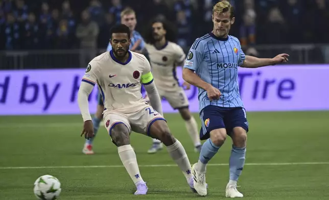 Chelsea's Reece James, left, and Djurgarden's Hampus Finndell, right, challenge for the ball during the Conference League semi-final first leg soccer match between Djurgardens IF and Chelsea FC in Stockholm, Sweden, Thursday, May 1, 2025. (Jonas Ekstroemer/TT News Agency via AP)