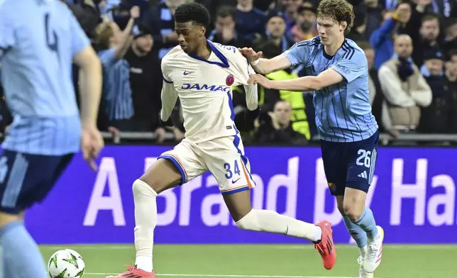 Chelsea's Josh Acheampong, left, and Djurgardens August Priske, right, challenge for the ball during the Conference League semi-final first leg soccer match between Djurgardens IF and Chelsea FC in Stockholm, Sweden, Thursday, May 1, 2025. (Jonas Ekstroemer/TT News Agency via AP)