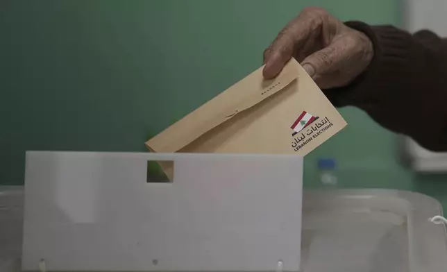 A Lebanese man casts his ballot at a polling station during municipal elections in the southern suburbs of Beirut, Lebanon, Sunday, May 4, 2025. (AP Photo/Hassan Ammar)