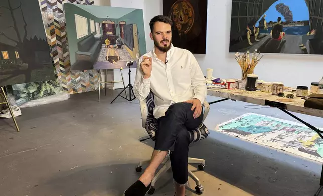 Andrei Kozlov, an artist who was taken hostage by Hamas during the Oct. 7, 2023, attack on Israel, speaks with The Associated Press during an interview Monday, May 19, 2025, at his studio in New York.