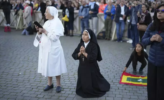 Sor Clara a nun from Peru prays during the speech of the newly elected Pope Leo XIV at the Vatican, Thursday, May 8, 2025. (AP Photo/Francisco Seco)