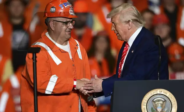 President Donald Trump greets steelworker Brian Pavlack as he speaks at the U.S. Steel Mon Valley Works-Irvin plant, Friday, May 30, 2025, in West Mifflin, Pa. (AP Photo/David Dermer)