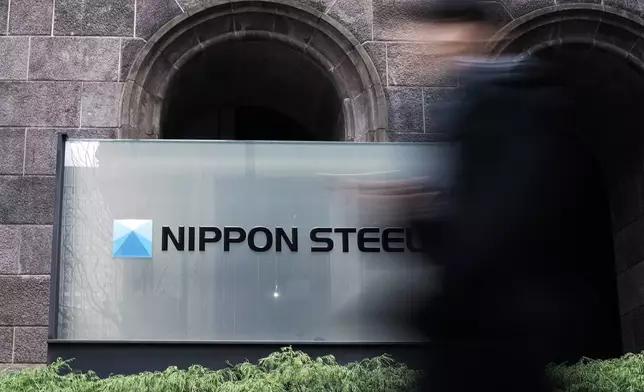 FILE - A person walks past a Nippon Steel Corporation sign at the company headquarters on Jan. 7, 2025, in Tokyo. (AP Photo/Eugene Hoshiko, File)
