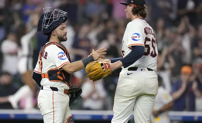 Houston Astros relief pitcher Forrest Whitley (55) celebrates the Astros' win over the Athletics with catcher Cesar Salazar, left, during the ninth inning of a baseball game, Tuesday, May 27, 2025, in Houston. (AP Photo/Karen Warren)