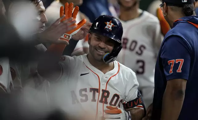 Houston Astros' Jose Altuve celebrates his two-run home run, against the Athletics, with teammates in the dugout during the fourth inning of a baseball game, Tuesday, May 27, 2025, in Houston. (AP Photo/Karen Warren)