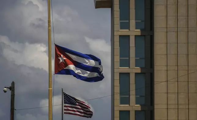 FILE - A Cuban flag is seen next to an American flag outside the U.S. embassy in Havana, Cuba, May 17, 2022. (AP Photo/Ramon Espinosa, File)