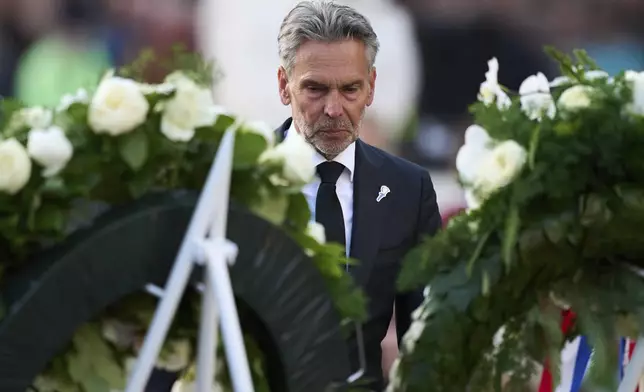 Netherlands' Prime Minister Dick Schoof lays a wreath during a solemn annual national service to commemorate the war dead in Amsterdam, Netherlands, Sunday, May 4, 2025. (AP Photo/Peter Dejong)