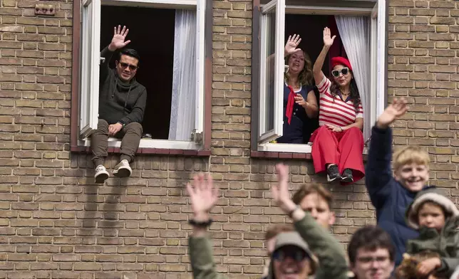 People wave as dozens of World War II veterans take part in a Liberation Day parade in Wageningen, Netherlands, Monday, May 5, 2025. (AP Photo/Peter Dejong)