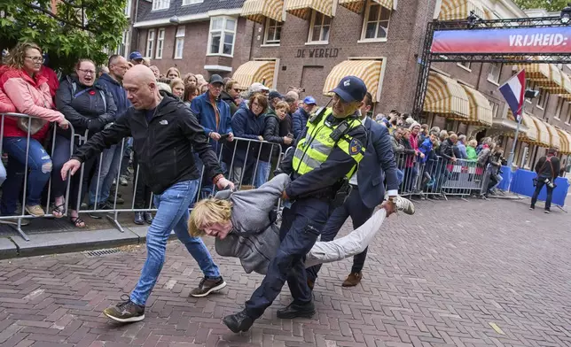 Police arrests a pro-Palestine demonstrator as dozens of World War II veterans gathered for Liberation Day celebrations in Wageningen, Netherlands, Monday, May 5, 2025. (AP Photo/Peter Dejong)