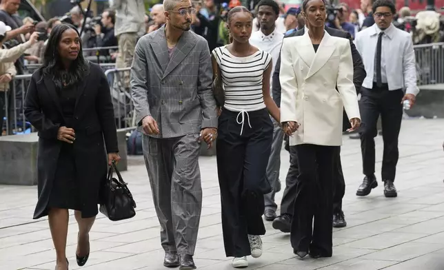 Quincy Combs, second from left, and Chance Combs center, arrive at Manhattan federal court, Tuesday, May 13, 2025, in New York. (AP Photo/Seth Wenig)