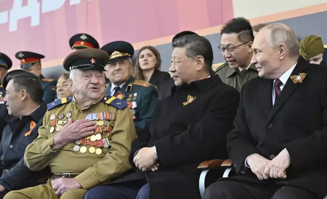 Russian President Vladimir Putin, right, and Chinese President Xi Jinpin, centre, wait for the start of the Victory Day military parade in Moscow, Russia, Friday, May 9, 2025, during celebrations of the 80th anniversary of the Soviet Union's victory over Nazi Germany during the World War II. (Mikhail Korytov/Photo host agency RIA Novosti via AP)