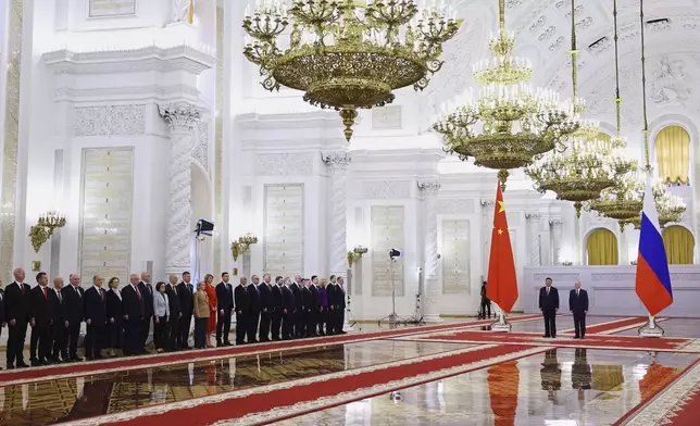 Members of the delegations, led by Russian President Vladimir Putin, right, and Chinese President Xi Jinping, second right, attend a welcoming ceremony before their talks at the Kremlin in Moscow, Russia, Thursday, May 8, 2025. (Evgenia Novozhenina/ Pool Photo via AP)