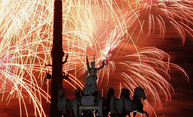 Fireworks explode over Quadriga on the Arc de Triumph and the Victory Monument on Poklonnaya Hill during celebrations of the 80th anniversary of the Soviet Union's victory over Nazi Germany during the World War II, in Moscow, Russia, Friday, May 9, 2025. (AP Photo/Pavel Bednyakov)