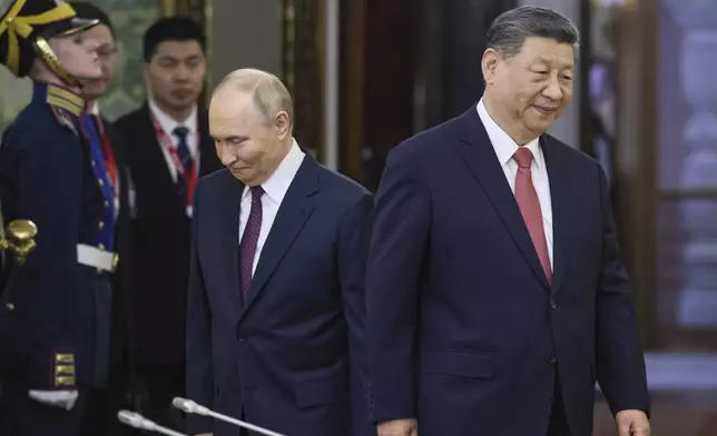 Russian President Vladimir Putin, center left, and China's President Xi Jinping, right, arrive for their talks at the Kremlin in Moscow, Russia, Thursday, May 8, 2025, ahead of celebrations of the 80th anniversary of the Soviet Union's victory over Nazi Germany during the World War II. (Yuri Kochetkov/Pool Photo via AP)