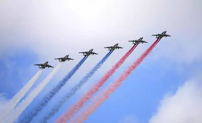 Russian Air Force Su-25 jets fly over Red Square leaving trails of smoke in the colours of the Russian national flag during the Victory Day military parade rehearsal in Moscow, Russia, on Monday, May 5, 2025, to mark 80th anniversary of the end of World War II. (AP Photo/Alexander Zemlianichenko)