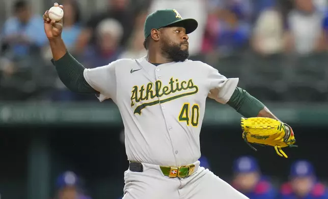 Oakland Athletics starting pitcher Luis Severino throws a pitch to the Texas Rangers during the first inning of a baseball game Wednesday, April 30, 2025, in Arlington, TX. (AP Photo/Julio Cortez)