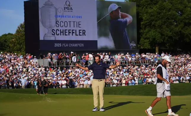 Scottie Scheffler celebrates after winning the PGA Championship golf tournament at the Quail Hollow Club, Sunday, May 18, 2025, in Charlotte, N.C. (AP Photo/Matt York)