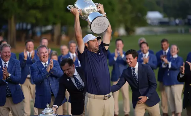 Scottie Scheffler holds the Wanamaker trophy after winning after winning the PGA Championship golf tournament at the Quail Hollow Club, Sunday, May 18, 2025, in Charlotte, N.C. (AP Photo/David J. Phillip)