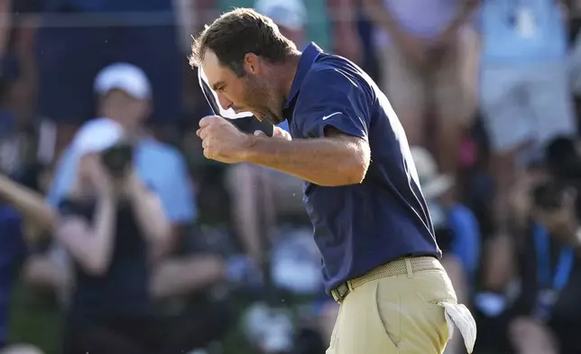 Scottie Scheffler celebrates after winning the PGA Championship golf tournament at the Quail Hollow Club, Sunday, May 18, 2025, in Charlotte, N.C. (AP Photo/David J. Phillip)