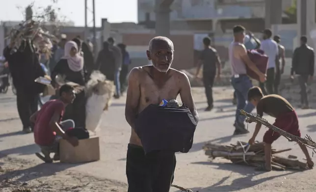 Palestinians carry boxes containing food and humanitarian aid packages delivered by the Gaza Humanitarian Foundation, a U.S.-backed organization approved by Israel, in Rafah, southern Gaza Strip, on Tuesday, May 27, 2025. (AP Photo/Abdel Kareem Hana)