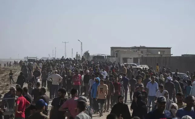 Palestinians heading to receive food and humanitarian aid packages from the Gaza Humanitarian Foundation, a U.S.-backed group approved by Israel, in Rafah, southern Gaza Strip on Tuesday, May 27, 2025. (AP Photo/Abdel Kareem Hana)