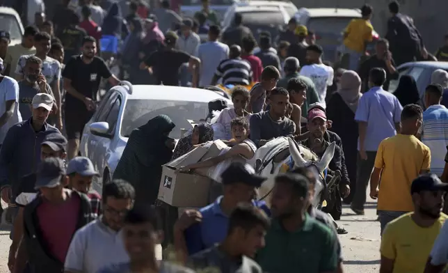Palestinians heading to receive food and humanitarian aid packages from the Gaza Humanitarian Foundation, a U.S.-backed group approved by Israel, in Rafah, southern Gaza Strip on Tuesday, May 27, 2025. (AP Photo/Abdel Kareem Hana)