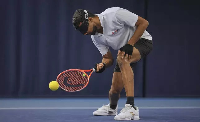 Blind tennis champion Naqi Rizvi plays a shot during a visually impaired tennis training session in London, Tuesday, May 20, 2025. (AP Photo/Kin Cheung)