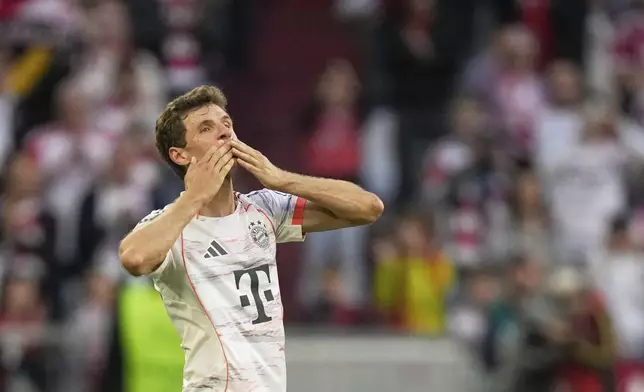 Bayern's Thomas Mueller greets supporters after being substituted during the German Bundesliga soccer match between FC Bayern Munich and Borussia Moenchengladbach in Munich, Germany, Saturday, May 10, 2025. (AP Photo/Matthias Schrader)