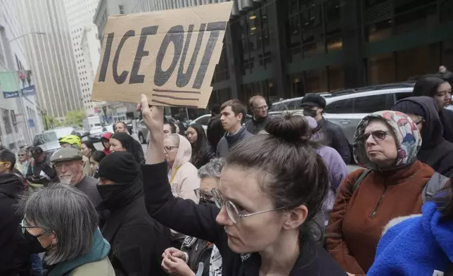 FILE - A person holds up a sign during a news conference and rally by immigrant justice organizations and advocates protesting ICE arrests in San Francisco, Wednesday, May 28, 2025. (AP Photo/Jeff Chiu, File)