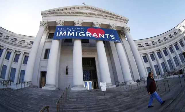 FILE - A banner to welcome immigrants is placed over the main entrance to the Denver City and County Building in Denver on Feb. 26, 2018. (AP Photo/David Zalubowski, File)