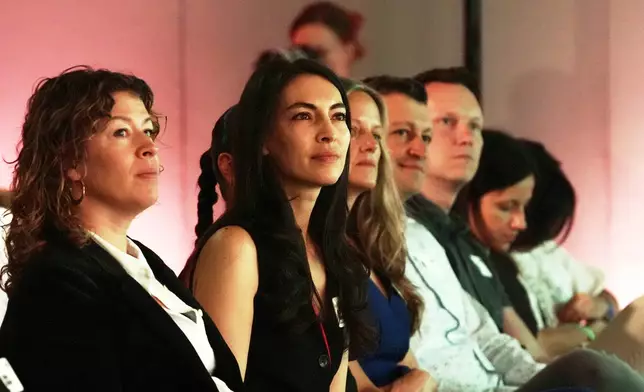 Attendees listen during the opening session of The Elevate Prize Foundation's Make Good Famous Summit, Tuesday, May 13, 2025, in Miami Beach, Fla. (AP Photo/Marta Lavandier)