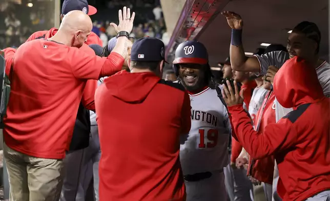 Washington Nationals designated hitter Josh Bell celebrates in the dugout after hitting a three-run home run during the 10th inning of a baseball game against the Seattle Mariners Thursday, May 29, 2025, in Seattle. (AP Photo/Ryan Sun)