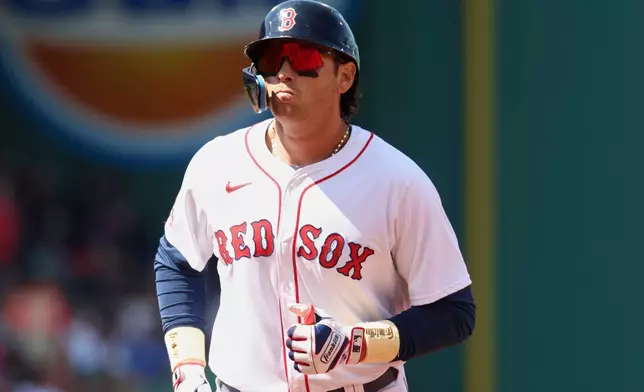 Boston Red Sox's Triston Casas heads to the dugout after flying out to left field during the fourth inning of a baseball game against the Seattle Mariners, Thursday, April 24, 2025, in Boston. (AP Photo/Mark Stockwell)
